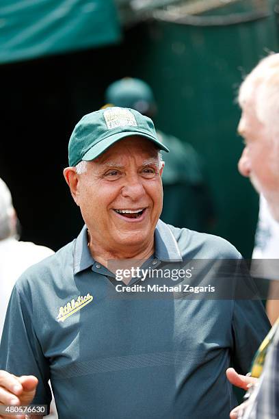 Owner Lew Wolff of the Oakland Athletics stands behind the backstop during the game between the Athletics and the Colorado Rockies at O.co Coliseum...