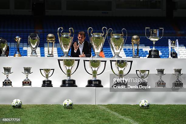 Iker Casillas poses behind trophies he has won during his career in Real Madrid after holding a press conference with Real president Florentino Perez...