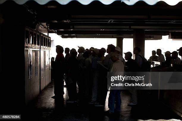 Punters watch a race on the betting screens during Keirin races at Kawasaki Velodrome on July 11, 2015 in Kawasaki, Japan. Keirin is a form of cycle...