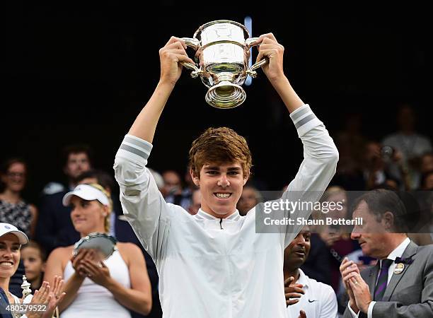 Reilly Opelka of the United States celebrates with the trophy after winning in the Final of the Boys Singles against Mikael Ymer of Sweden during day...