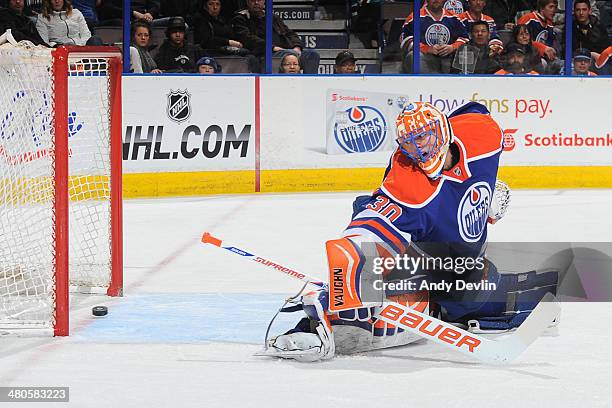 Ben Scrivens of the Edmonton Oilers looks back as the puck crosses the goal line in a game against the San Jose Sharks on March 25, 2014 at Rexall...