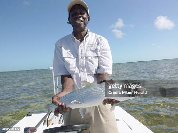 Bimini bonefish guide "Eagle Eyes" Fred Rolle holds up a bonefish caught and released by Sue Cocking on fly rod recently.