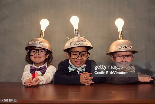 nerd children wearing lighted mind reading helmets - association bildbanksfoton och bilder