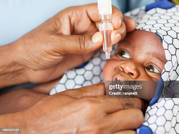 african baby receiving vaccine - baby vaccination stock pictures, royalty-free photos & images