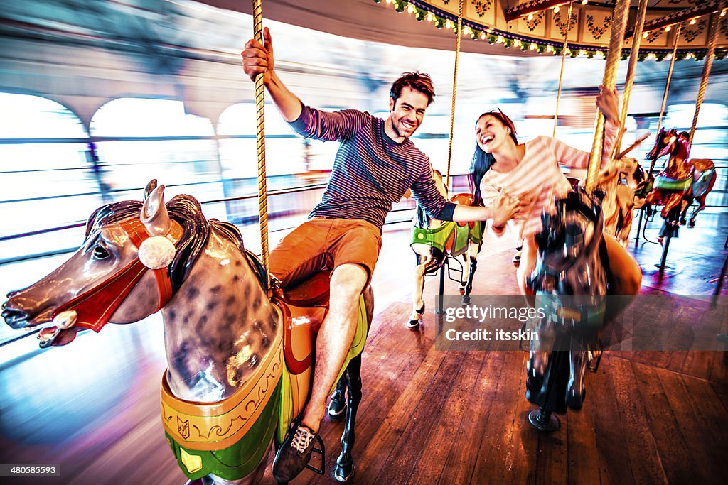 Couple riding merry-go-round in LA