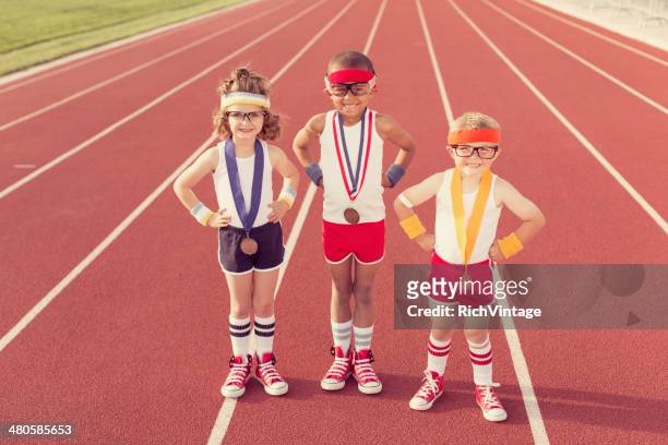 children dressed as nerds at track wearing medals - sportsperson medal stock pictures, royalty-free photos & images