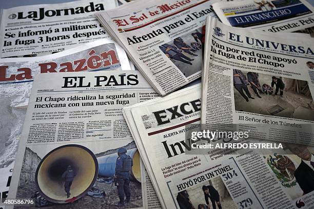 View of the front pages of several newpapers in Mexico City on July 13 reading about Mexican drug lord Joaquin "El Chapo" Guzman's escape from the...
