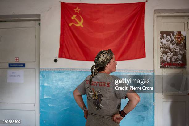 Communist flag hangs on a wall inside a rebel base as Pro-Russian rebels fighters of the Prezrak batallion fighting on the side of self-proclaimed...