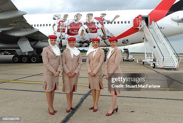 Air stewards pose for picture in front of the Arsenal's Emirates plane as they travel to Singapore for the Barclays Asia Trophy at Stansted Airport...