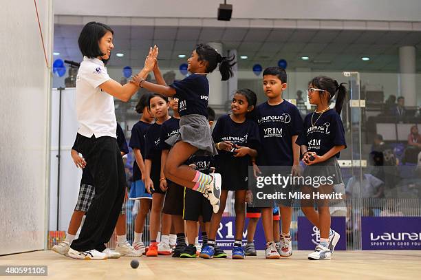 Squash player Nicol David interacts with children during a visit to a childrens clinic at Bukit Jalil School ahead of the 2014 Laureus World Sports...