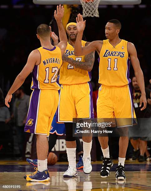 Jordan Hill of the Los Angeles Lakers celebrates his basket with Kendall Marshall and Wesley Johnson of the Los Angeles Lakers during a win over the...