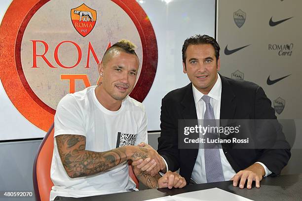 Radja Nainggolan , with AS Roma CEO Italo Zanzi, as he renews his contract with AS Roma on July 13, 2015 in Rome, Italy.