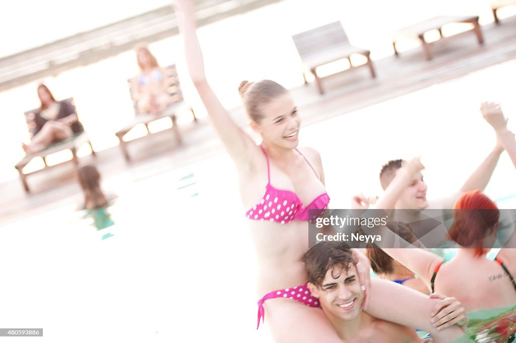 Group of young adult people having fun on swimming pool