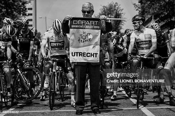 Utrecht's mayor Jan van Zanen gives the start between Australia's Rohan Dennis , wearing the overall leader's yellow jersey, and Netherlands' Tom...