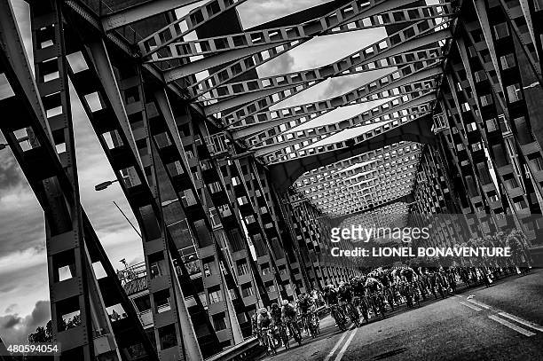 The pack rides on a bridge during the 166 km second stage of the 102nd edition of the Tour de France cycling race on July 5 between Utrecht and...