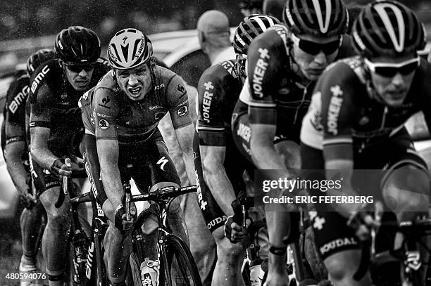 Germany's Tony Martin rides in the pack under heavy rain during the 166 km second stage of the 102nd edition of the Tour de France cycling race on...