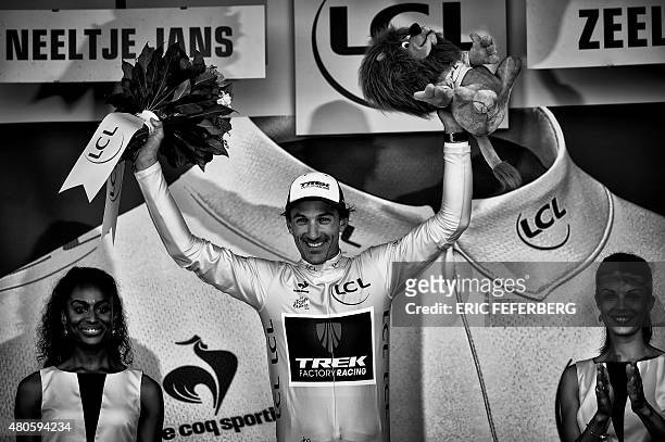 Switzerland's Fabian Cancellara celebrates his overall leader yellow jersey on the podium at the end of the 166 km second stage of the 102nd edition...