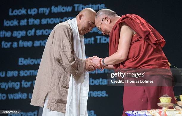 The XIV Dalai Lama greets the Chinese writer Liao Yiwu during his 80th birthday celebrations at the 'Jahrhunderthalle' on July 13, 2015 in Frankfurt,...