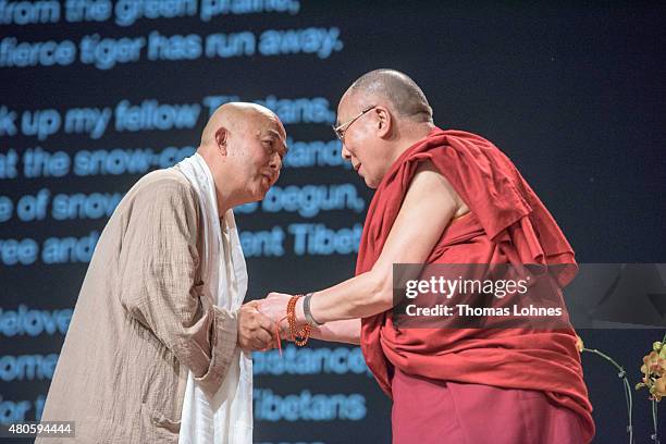 The XIV Dalai Lama greets the Chinese writer Liao Yiwu during his 80th birthday celebrations at the 'Jahrhunderthalle' on July 13, 2015 in Frankfurt,...