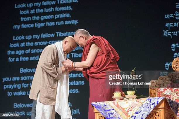 The XIV Dalai Lama greets the Chinese writer Liao Yiwu during his 80th birthday celebrations at the 'Jahrhunderthalle' on July 13, 2015 in Frankfurt,...