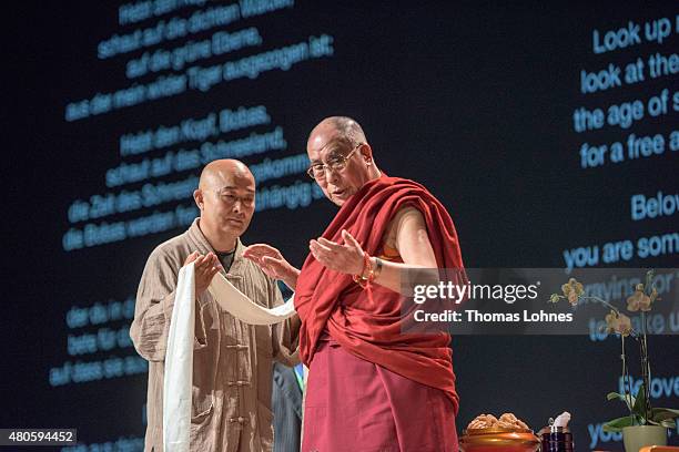 The XIV Dalai Lama greets the Chinese writer Liao Yiwu during his 80th birthday celebrations at the 'Jahrhunderthalle' on July 13, 2015 in Frankfurt,...