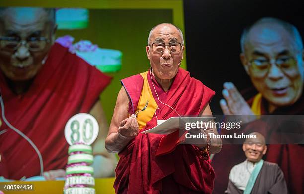 The XIV Dalai Lama eats birthday cake during his 80th birthday celebrations at the 'Jahrhunderthalle' on July 13, 2015 in Frankfurt, Germany.