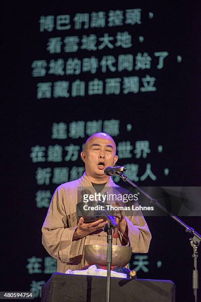The Chinese writer Liao Yiwu performs a poem with a singing bowl during the XIV Dalai Lama's 80th birthday celebrations at the 'Jahrhunderthalle' on...