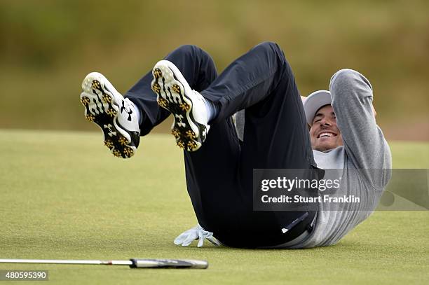 Jordan Spieth of the United States falls over laughing as he plays a practice round ahead of the 144th Open Championship at The Old Course on July...