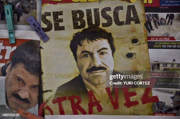 Poster with the face of Mexican drug lord Joaquin "El Chapo" Guzman, reading "Wanted, Again", is displayed at a newsstand in one Mexico City's major...