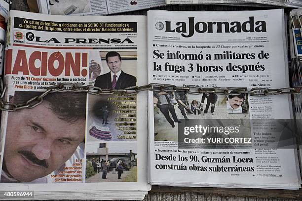 Newspapers with images of Mexican drug lord Joaquin "El Chapo" Guzman, are displayed at a newsstand in one Mexico City's major bus terminals on July...