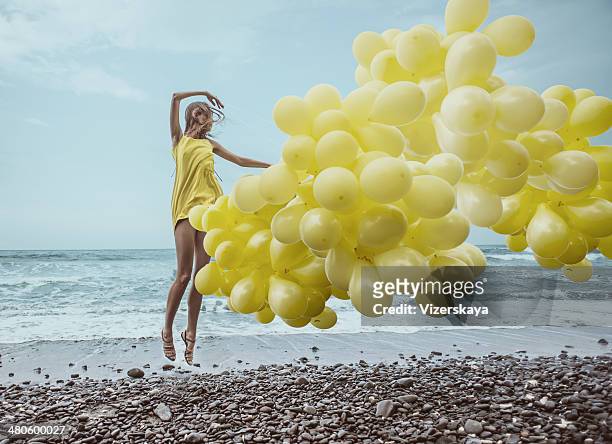 girl with yellow balloons - yellow dress stock pictures, royalty-free photos & images