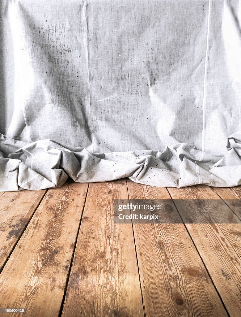 Unbleached textile on rustic floor