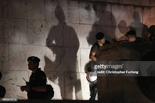 Riot police guard the Greek parliament as protesters gather outside to demonstrate against austerity after an agreement for a third bailout with...