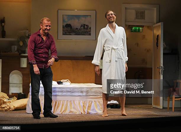 Steffan Rhodri and Stephen Merchant bow at the curtain call during the press night performance of "The Mentalists" at Wyndhams Theatre on July 13,...
