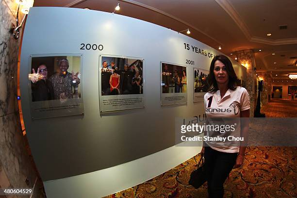 Laureus Academy member Nadia Comaneci poses at the Fifteen Years of Laureus Exhibition ahead of the 2014 Laureus World Sports Awards at the...