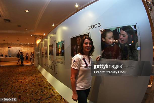 Laureus Academy member Nadia Comaneci poses at the Fifteen Years of Laureus Exhibition ahead of the 2014 Laureus World Sports Awards at the...
