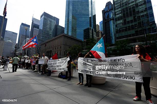 Protesters demonstrate at the Puerto Rican debt talks outside Citibank Inc. Headquarters on Park Avenue in New York, U.S., on Monday, July 13, 2015....