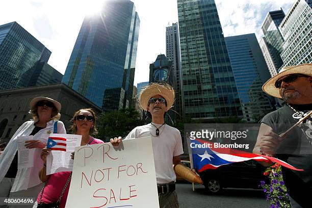 Protesters demonstrate at the Puerto Rican debt talks outside Citibank Inc. Headquarters on Park Avenue in New York, U.S., on Monday, July 13, 2015....
