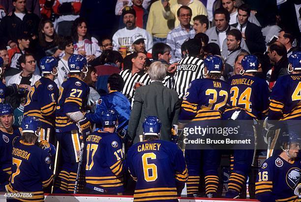 Players of the Buffalo Sabres go into the stands as the referees try to break up a fight that happened with the fans during an NHL game against the...