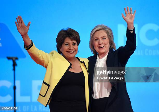 President and CEO of La Raza Janet Murguia and Democratic presidential candidate and former Secretary of State Hillary Clinton wave to the audience...