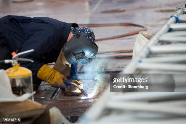 Work welds on the deck of the Royal Navy's new Queen Elizabeth class aircraft carrier, manufactured by the Aircraft Carrier Alliance, a joint...