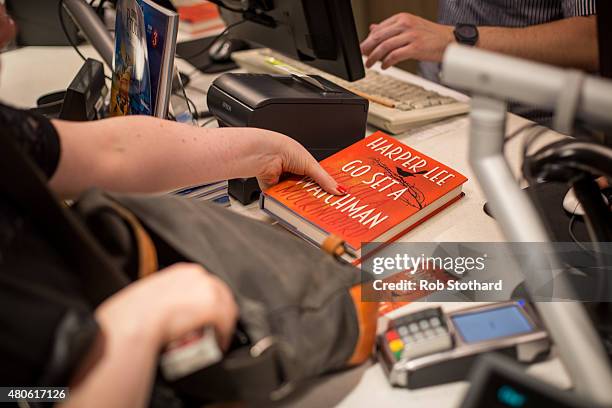 People buy "Go Set A Watchman" by Harper Lee shortly after midnight at Foyles book shop on July 14, 2015 in London, England. Go Set a Watchman was...