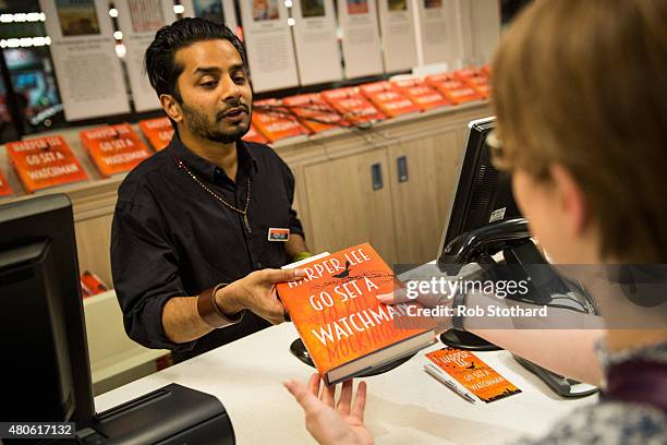 People buy "Go Set A Watchman" by Harper Lee shortly after midnight at Foyles book shop on July 14, 2015 in London, England. Go Set a Watchman was...