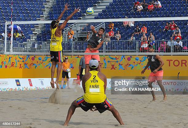 Mexico's Juan Virgen looks on as Rodolfo Ontiveres smashes the ball at Venezuela's Jackson Henriquez and Jesus VillaFane during the Men's Beach...