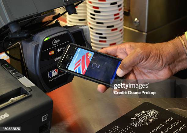 Ozzie Smith uses Apple Pay at the Home Run Derby at Great American Ball Park on July 13, 2015 in Cincinnati, Ohio.