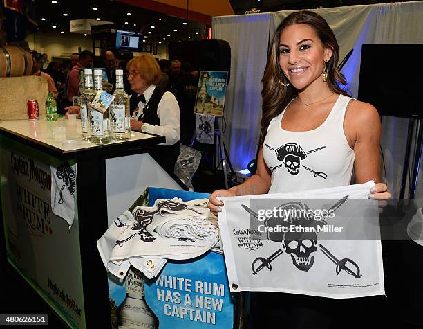 Model Jackie Savitt hands out Captain Morgan Caribbean white rum flags at the Diageo booth at the 29th annual Nightclub & Bar Convention and Trade...