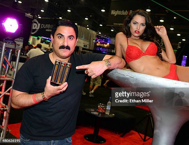 Television personality Reza Farahan and a model display his Phantom Smoke hookah products at the 29th annual Nightclub & Bar Convention and Trade...