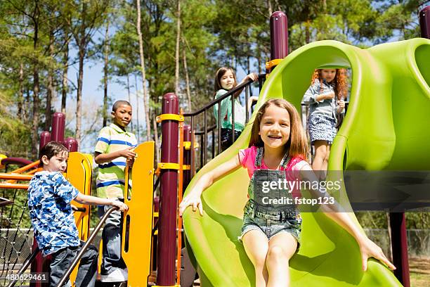 elementary children play at school recess or park on playground. - klimrek stockfoto's en -beelden