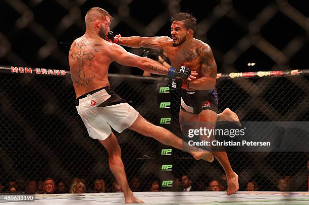 Dennis Bermudez punches Jeremy Stephens in their featherweight fight during the UFC 189 event inside MGM Grand Garden Arena on July 11, 2015 in Las...