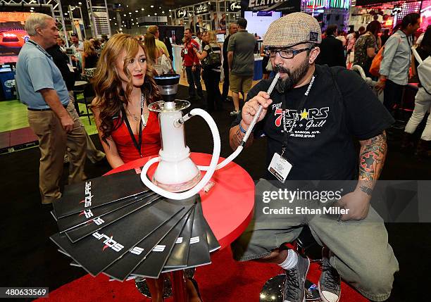 An attendee tries products at the Square electronic cigarette booth at the 29th annual Nightclub & Bar Convention and Trade Show at the Las Vegas...